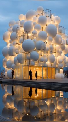 people standing in front of a building with large balloons on the roof and around it