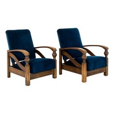 a pair of wooden chairs with blue velvet upholstered seat cushions and wood arms