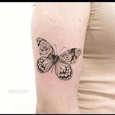 a woman's arm with a butterfly and rose tattoo on the back of it