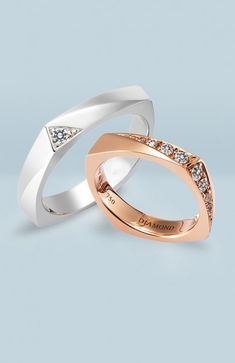 two white and rose gold wedding rings with diamonds on top, one in the middle