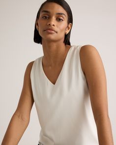 We're all about upgrading the essentials. This classic tank is made from washable silk, with a bit of stretch for the perfect fit. Effortless. A-line. No dry cleaning runs needed. Perfect for layering at the office or days lounging at home. Plus, silk fiber contains 18 kinds of amino acids that make it amazing for skin nourishment, hypo-allergenic, and naturally thermoregulating to help maintain body temperature. Also offered in sizes 1X - 3X.  | Quince | Women's 100% Washable Silk Stretch Tank V-neck Camisole For Spring Workwear, Elegant Summer Tank Top For Workwear, Classic Fitted Camisole For Spring, Classic Fitted Spring Camisole, Classic White Tank Top For Spring, White Sleeveless Top With Minimal Stretch, White Minimal Stretch Sleeveless Top, Classic Fitted Sleeveless Camisole, Spring Workwear Tank Camisole