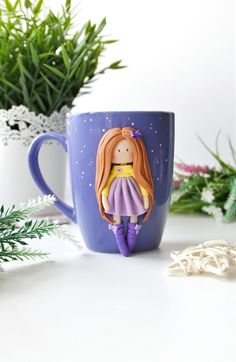 a purple coffee mug with a doll on it