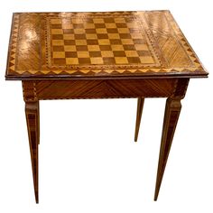 a wooden table with a chess board on it's top and two legs at the base