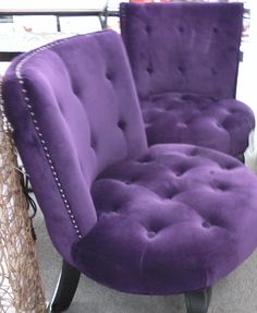 a purple chair sitting on top of a wooden table