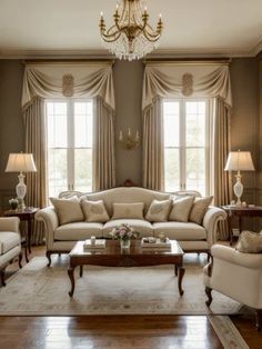 a living room filled with furniture and a chandelier hanging from the side of a window