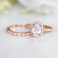 Gorgeous Rainbow Moonstone Ring ►Base Metal: Sterling Silver ►Plating: 14K Rose Gold Vermeil (S925) ►Accented with Simulated Diamonds (CZ) Center Stone: Moonstone Color: Rainbow Stone Cut: Oval Gem size: 8.0 x 6.0 mm Carat Weight: 1.21 ct. (approx.) Gemstone creation: Natural ►This ring can be paired with one or two matching Milgrain bands of your choice (select option from the drop-down menu). ►Handling time: 1-3 business days ►Free domestic shipping. Usually takes 2-5 business days. ►Wrapped & Rose Gold Round Moonstone Ring With Halo, Celestial Rose Gold Crystal Promise Ring, Rose Gold Moonstone Halo Promise Ring, Rose Gold Celestial Moonstone Ring For Anniversary, Celestial Rose Gold Moonstone Ring For Anniversary, Celestial Rose Gold Gemstone Rings, Rose Gold Halo Moonstone Ring For Wedding, Ethereal Rose Gold Jewelry For Anniversary, Engagement Roses