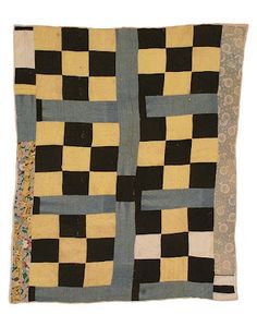 a black and yellow quilt with squares on it