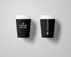 two coffee cups with the words espresso boutique on them sitting next to each other