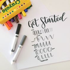 some crayons and markers are on top of a paper with the words get started