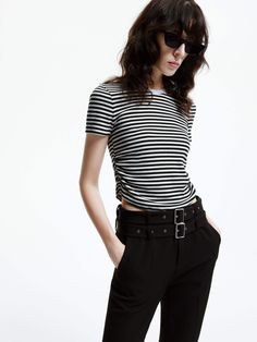 MO&Co. Women's Side Pleated Cropped T-shirt This T-shirt is made from comfortable cotton blend fabric that offers a flattering and short cut. The side pleated details and classic stripes add a touch of sophistication, making it a perfect match for high-waisted skirts and pants. Features : - Cropped, slim ribbed knit fit- Round neck, double side pleats- Classic black and white stripes Code: MBD1TEET09The back length of size S is 46.8cmMATERIALS & CARE Material: 96.4% Cotton 3.6% SpandexREMINDER: Chic Striped Crew Neck T-shirt, Summer Short Sleeve T-shirt With Striped Hem, Casual Fitted Top With Striped Hem, Black Summer Tops With Striped Hem, Black Summer Top With Striped Hem, Black Short Sleeve Top With Striped Hem, Fitted Casual Tops With Contrast Stripes, Fitted Casual Top With Contrast Stripes, Casual Fitted Top With Contrast Stripes