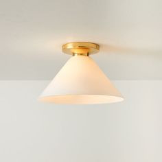 a light fixture in a room with white walls