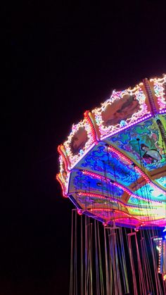 an illuminated carnival ride at night time