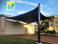 a black shade covering a house in front of it