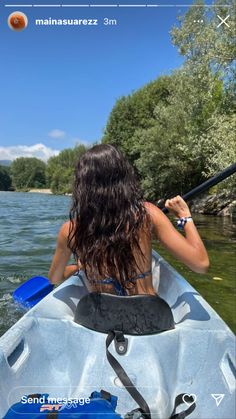 a woman in a kayak paddling on the water