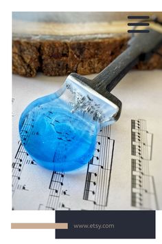 a close up of a brush on top of sheet music