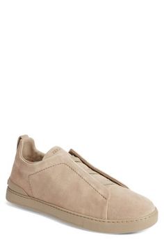 This soft and supple suede sneaker slips on easily with crisscrossed elastic at the vamp and is set on a tonal rubber cupsole for a casual aesthetic. Pull-on style Leather upper and lining/synthetic sole Made in Italy Designer Shoes Modern Suede Slip-on Sneakers, Slip-on Sneakers With Suede Lining, Suede Slip-on Sneakers For Streetwear, Suede Low-top Slip-ons, Suede Slip-on Low-top Sneakers, Suede Slip-on Sneakers With Rubber Sole For Streetwear, Comfortable Suede Slip-on Sneakers With Textured Sole, Comfortable Suede Sneakers With Leather Sole, Casual Slip-on Sneakers With Suede Lining