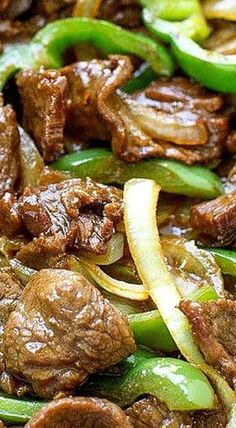 beef and peppers are being cooked in a skillet with onions, green peppers, and mushrooms