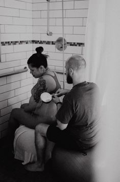 a man and woman are sitting in the shower