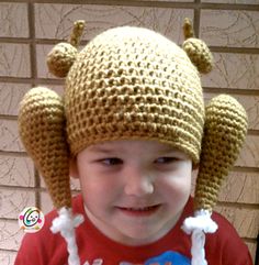 a young child wearing a crocheted hat with ears