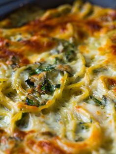 a casserole dish with cheese and spinach