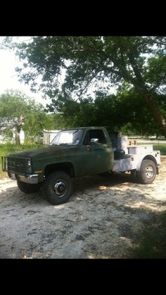 an old pick up truck is parked in the dirt