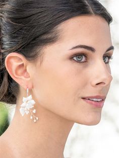 Pearl and Ivory Floral Bridal EarringsYou'll love our hand-crafted wedding earrings with light ivory resin flowers and lustrous freshwater pearls. These organic vine-style earrings topped with pave fishhooks are perfect for bridesmaids, brides or for any special occasion.Size: 2 1/2" long with 1/2" long pave fishhook tops and 1" wide.Color: Silver/Light Ivory.Style: 4667e.Need several pair of earrings for your bridal party? You can buy in bulk and save!Please allow 1 week for delivery.Shipping P Cream Dangle Jewelry For Wedding, Cream Pearl Drop Earrings For Wedding, Delicate Pearl White Flower Earrings For Wedding, Delicate White Pearl Earrings For Mother Of The Bride, Cream Dangle Earrings For Wedding, Delicate White Pearl Bridal Earrings, Delicate White Pearl Flower Earrings, Pearl White Wedding Jewelry With 3d Flowers, Pearl White Jewelry With 3d Flowers For Wedding