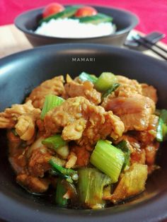 a bowl filled with meat and vegetables on top of a table