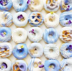 there are many donuts with different designs on them, and one has blue icing