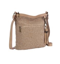 a beige handbag with tassels on the handles and shoulder strap, sitting against a white background