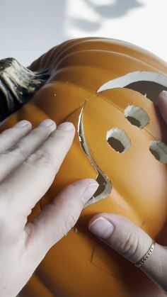 someone is peeling the side of a pumpkin