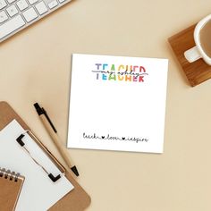 a notepad sitting on top of a desk next to a cup of coffee