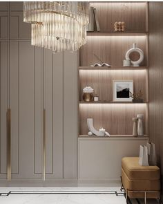 an elegant living room with gold accents and chandelier above the bookshelves