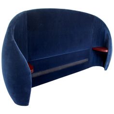 an upholstered blue couch with two red shelves on the back and one arm