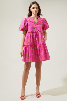 You'll be an oh-so-sweet sight to see in the Tune Floral Jeanne Bubble Sleeve Babydoll Dress! A cute pink and floral design decorate the puff sleeves around the shoulders and three layers of tiers which complement the dress. A split neckline is highlighted by billowy short sleeves in this mini dress. Perfect dress to take on your next vacation!- Split neckline- Bubble sleeves- Babydoll- Pocket- Color: Fuchsia Orange MulSize + Fit - Model is 5'8" and wearing size XS- Measurements taken from size Playful Floral Print Mini Dress, Playful Pink Dress For Garden Party, Playful Pink Floral Print Dresses, Cute Pink Puff Sleeve Mini Dress, Playful Floral Print Mini Dress For Spring, Pink Cotton Mini Dress For Brunch, Pink Cotton Mini Dress With Puff Sleeves, Cute Pink Tiered Mini Dress, Playful Pink V-neck Dress