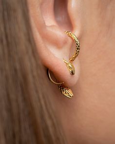 "Adorn your ears with this cute and stylish snake earring set, including gold plated hoop earrings that make a statement in animal jewelry fashion. These elegant earrings are the perfect accessory to enhance any outfit, adding a touch of whimsical charm and sophisticated charm. Embrace your wild side with these unique and eye-catching earrings that are sure to make you stand out from the crowd. Perfect for snake lovers and fashionistas alike, these earrings are a must-have addition to your jewelry collection. Set of Snake-shaped earrings, made in 24K gold-plated sterling silver or oxidized sterling silver. H O W  T O  O R D E R * Please use the drop-down menu to select your preference: * Select which of the snake combinaciones you would like. * Use the drop-down menu: * Select the quantity Animals Jewelry, Serpent Jewelry, Snake Lovers, Cute Snake, Snake Earrings, Ear Jacket, Animal Earrings, Stylish Earring, The Snake