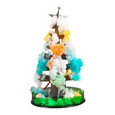 a small christmas tree made out of gummy bears and other colorful items on a stand