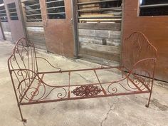 an old metal bed frame sitting on the ground