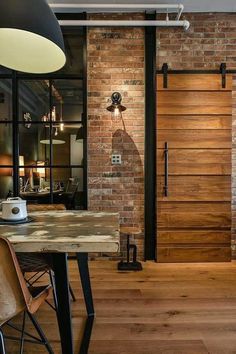 an image of a room with wooden floors and doors on the wall, which are open to let in light