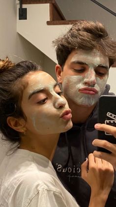 two people with face masks on taking a selfie