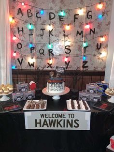 a welcome to harkins sign and dessert table