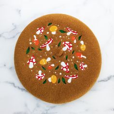 a cookie decorated with candy and candies on top of a marble countertop in the shape of a circle