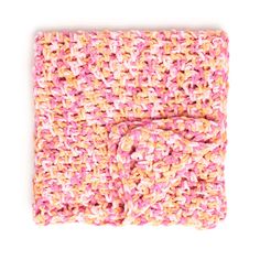 a pink and yellow crochet blanket on a white background with a bow tie