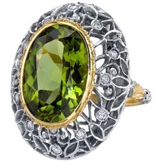 This is a truly beautiful ring, from the size and quality of peridot it features to the exquisite Florentine inspired craftsmanship. The large oval peridot is clear and crystalline, with bright, "Granny Smith" apple green color, set in 18k yellow gold to highlight its beauty. If August is your birth month, peridot is your birthstone. Sparkling round brilliant cut diamonds further adorn the white gold portion of the ring which has been intricately pierced, creating an elegant, regal appearance. Handmade in Italy. Peridot, 16.30 x 11.50 x 7.10mm, 8.85 carats Round brilliant cut diamonds, .24 carat total Ring size 7 Complimentary sizing as needed Peridot Engagement Rings, Granny Smith Apple, Expensive Rings, Beautiful Tiaras, Dome Ring, Granny Smith, Sapphire Diamond Ring, Domed Ring, Pretty Rings