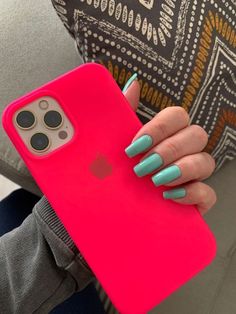 a woman's hand holding an iphone case with blue and pink nail polish on it