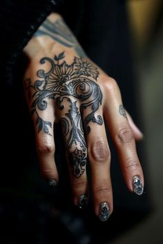 a woman's hand with tattoos on it