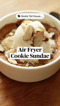 an air fryer cookie sundae in a white bowl on a wooden table with text overlay that reads, air fryer cookie sundae