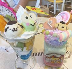 two desserts are sitting on a table with people in the background