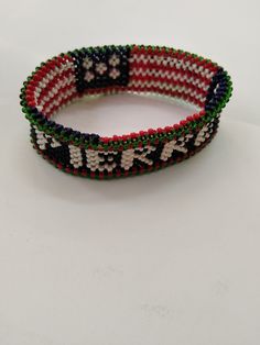 Get two of these for 40 USD Customized Handmade Flag Wrist Band, Kenyan Flag Wrist Band, Beaded Wrist Band, Bracelets, Bangles, Jewelry, Embroidery, Gifts for Him, Valentine Gifts. Flag Wrist Bands are very fashionable and are increasingly gaining popularity especially due to the patriotic aspect they portray. Get yourself one of our flag wrist bands or request for your custom colors or flag and we will craft it for you! Our flag bracelets are made with high quality beads and durable string. We Embroidery Gifts For Him, Kenyan Flag, Handmade Flags, Jewelry Embroidery, Band Bracelets, Embroidery Gifts, Personalized Bracelet, Wrist Band, Gift Items