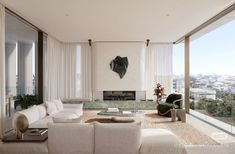 a living room filled with white furniture next to tall glass walls and floor to ceiling windows