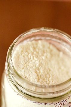 a jar filled with white powder sitting on top of a table